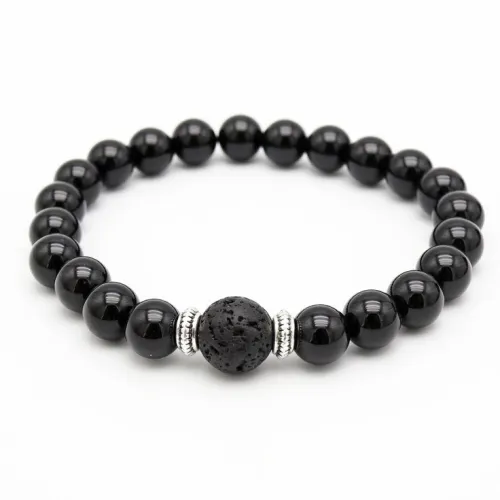 Hand holding obsidian in sunlight with nature background