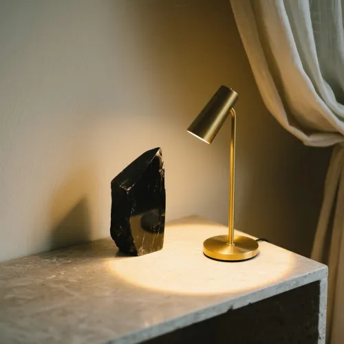 Hand wearing obsidian bracelet against nature backdrop symbolizing calm