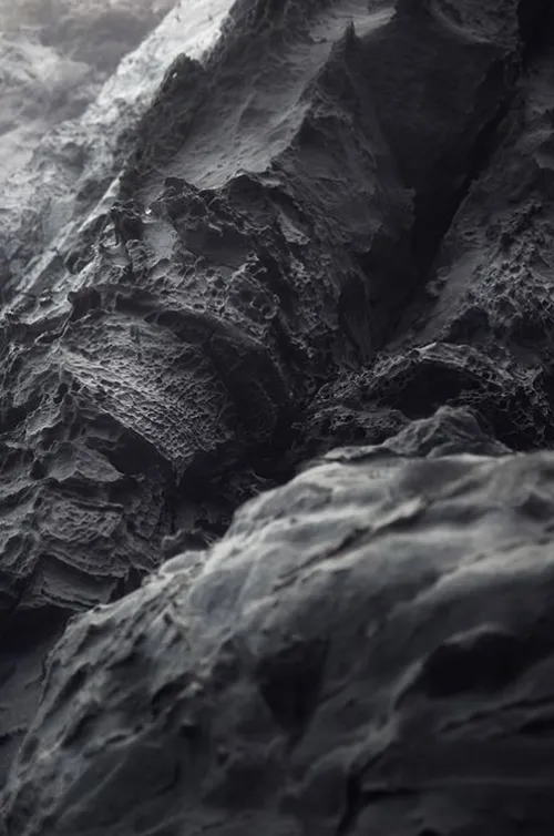 Obsidian stones arranged in circle around cup of tea with relaxing ambiance