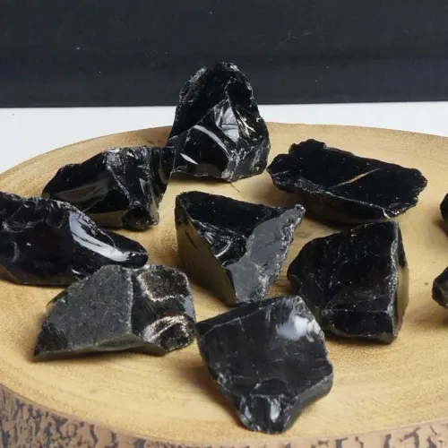 Person wearing black obsidian jewelry during daily activities