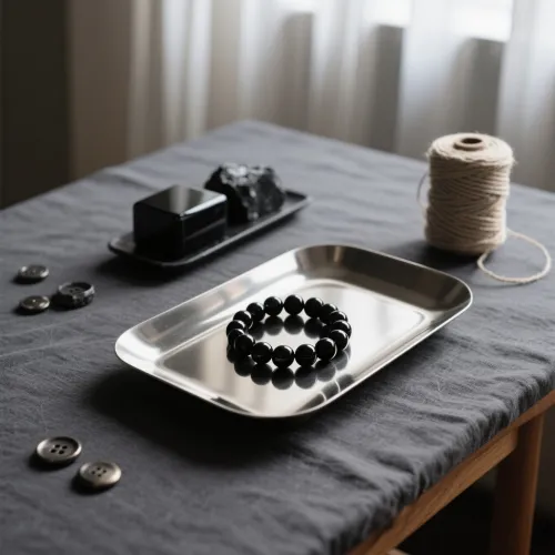 Worn hands holding obsidian stone demonstrating long-term use